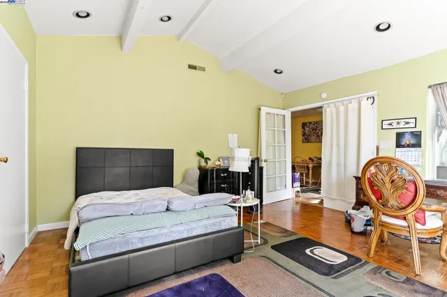 a bedroom with a bed and dresser