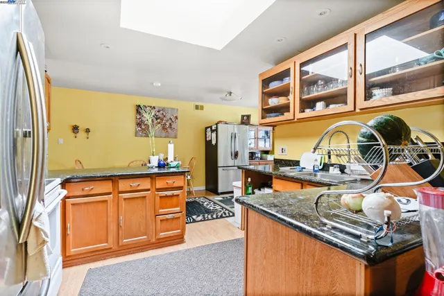 a kitchen with stainless steel appliances granite countertop a stove and a sink