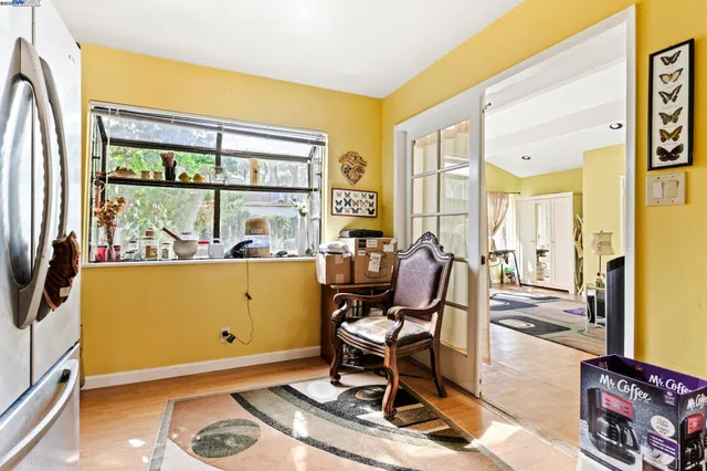 a view of a workspace with furniture and a window