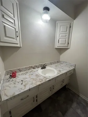a spacious bathroom with a granite countertop toilet and sink