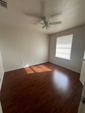 a view of walk in closet with wooden floor