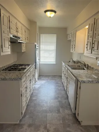 a kitchen with stainless steel appliances granite countertop a stove and a sink