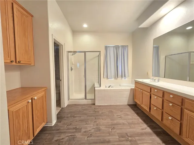 a bathroom with a tub sink and mirror