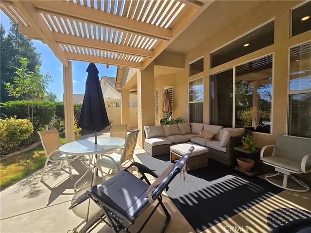 a view of a patio with table and chairs and potted plants
