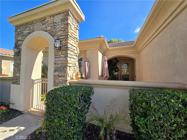 a front view of a house with plants