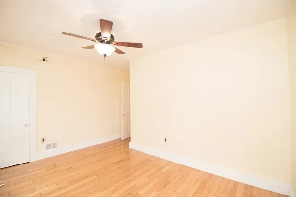 a view of a room with a ceiling fan