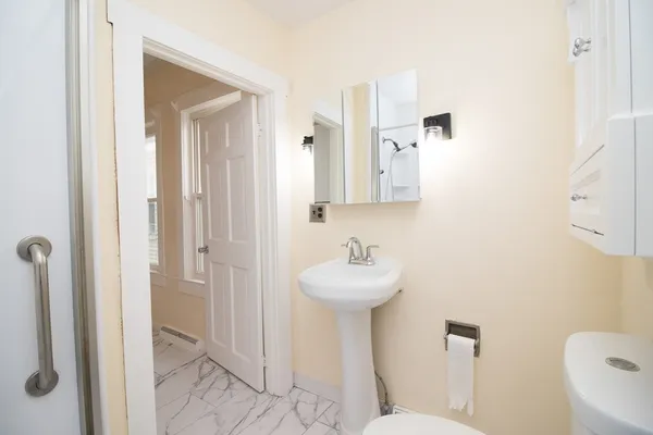a bathroom with a sink toilet and shower