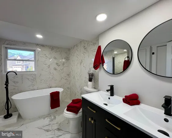 a bathroom with a bathtub sink and mirror