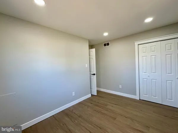a view of kitchen with stainless steel appliances refrigerator stove dining table and chairs