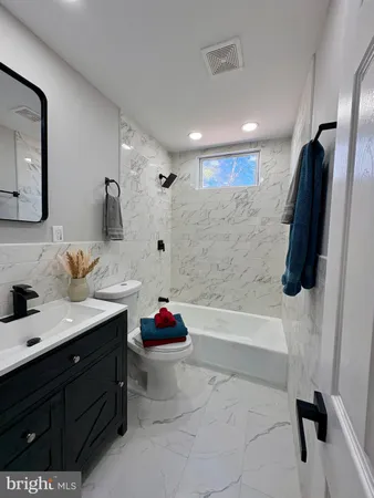 a kitchen with white cabinets and sink