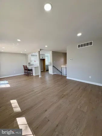 a kitchen with a sink cabinets and wooden floor