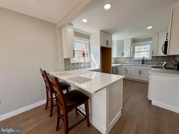 a kitchen with appliances a sink and cabinets