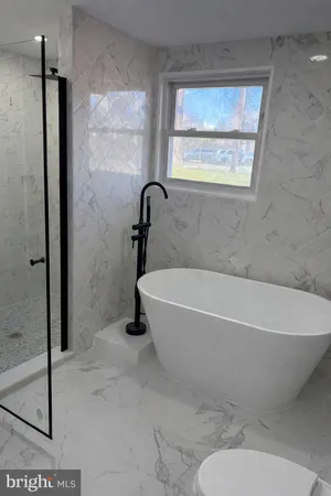 a bathroom with a shower and a sink