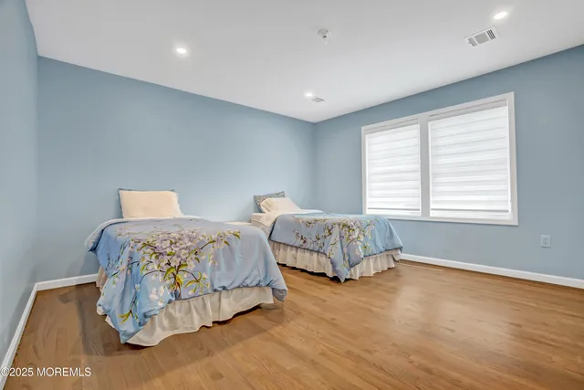 a bedroom with two beds and a window