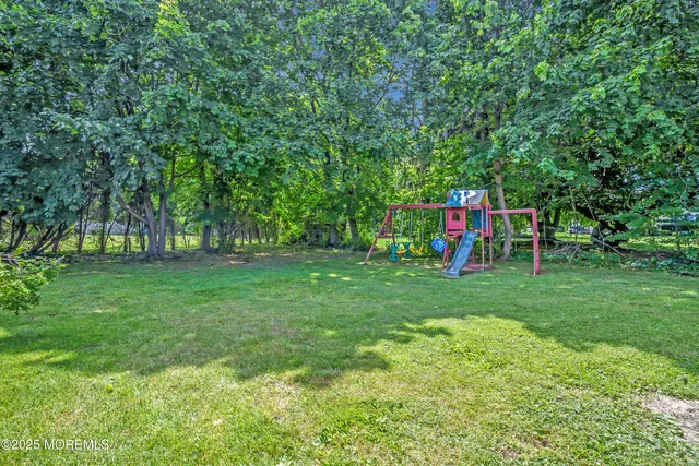 a view of a green field with sitting area