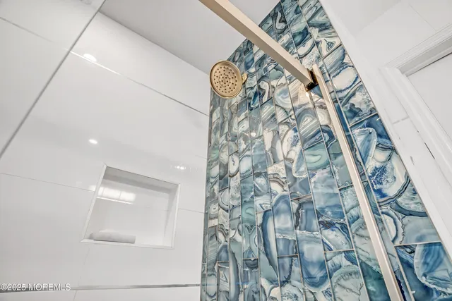 a front view of a house with a garden and trees