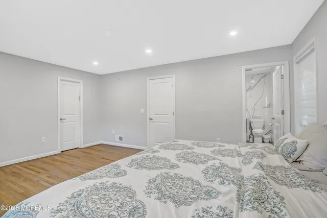 a bathroom with a sink a toilet and a large mirror