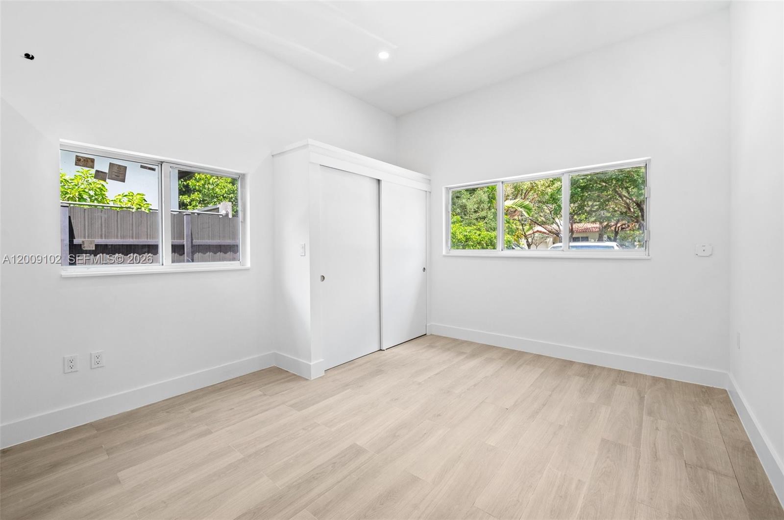 330 Southwest 27th Road Miami, FL 33129 - Photo 30 of 62 an empty room with wooden floor and windows