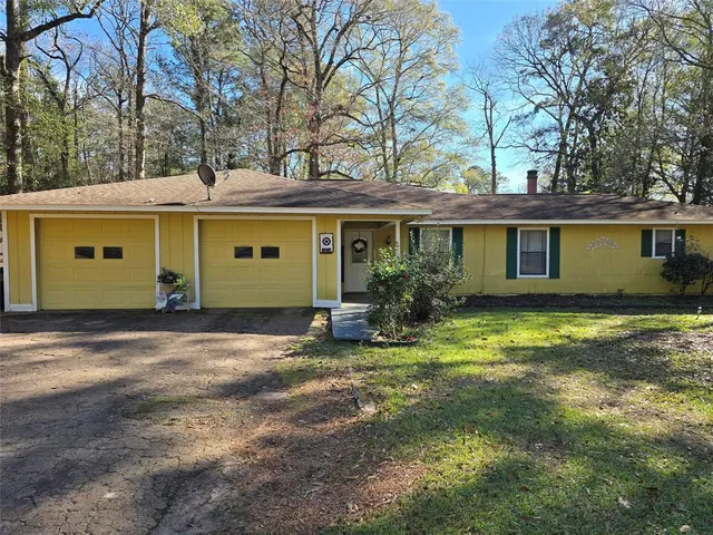 a view of a house with a yard and garage