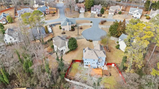 an aerial view of residential houses with outdoor space
