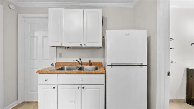 a white refrigerator freezer sitting inside of a kitchen