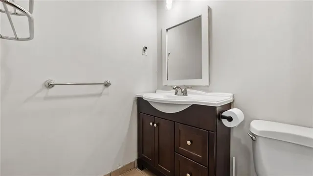a bathroom with a sink vanity and a toilet