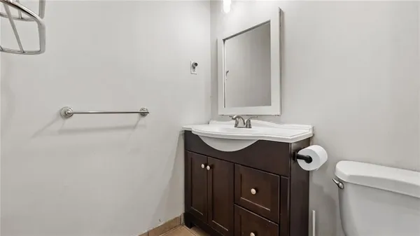 a bathroom with a sink vanity and a toilet