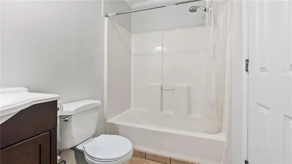 a white toilet sitting next to a bath tub