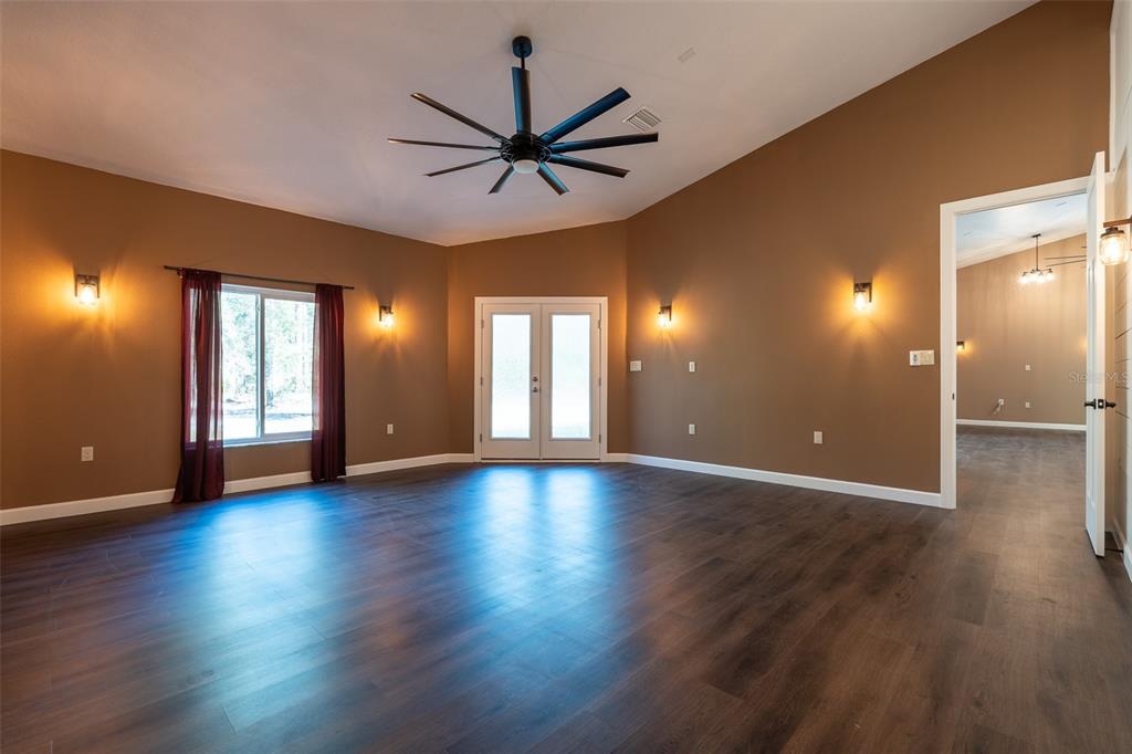 6425 Cartwrite Road Spring Hill, FL 34609 - Photo 21 of 74 a view of an empty room with window and wooden floor