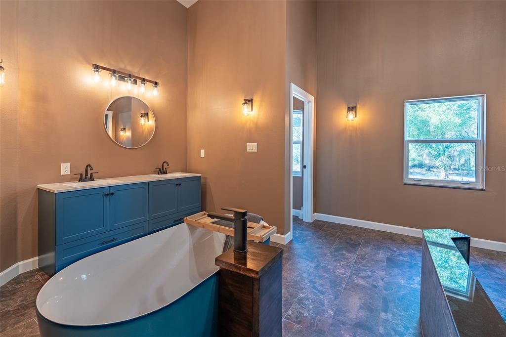 6425 Cartwrite Road Spring Hill, FL 34609 - Photo 25 of 74 a bathroom with a sink mirror and a vanity
