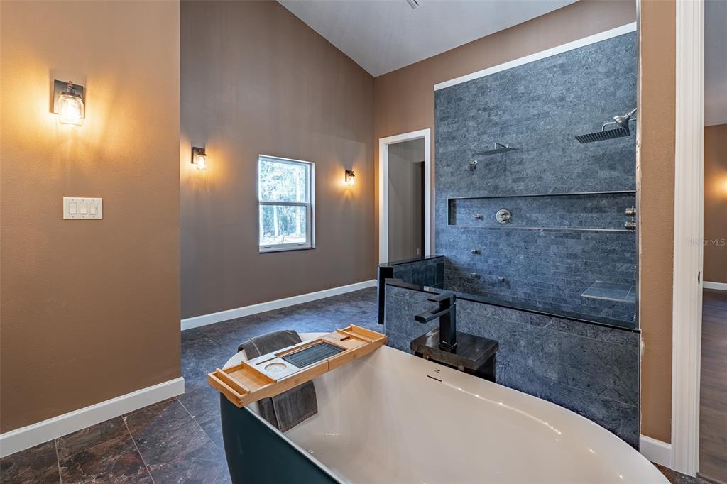 6425 Cartwrite Road Spring Hill, FL 34609 - Photo 26 of 74 a bathroom with a sink and a mirror