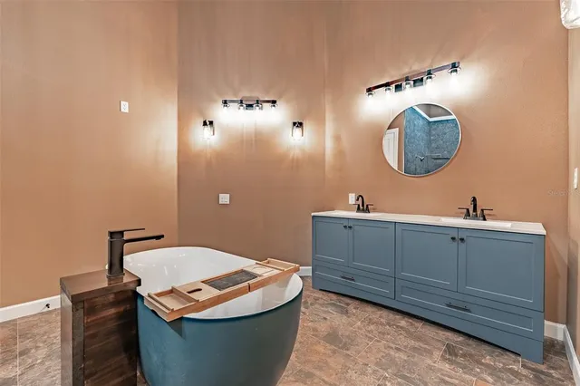 an empty room with wooden floor chandelier fan and windows