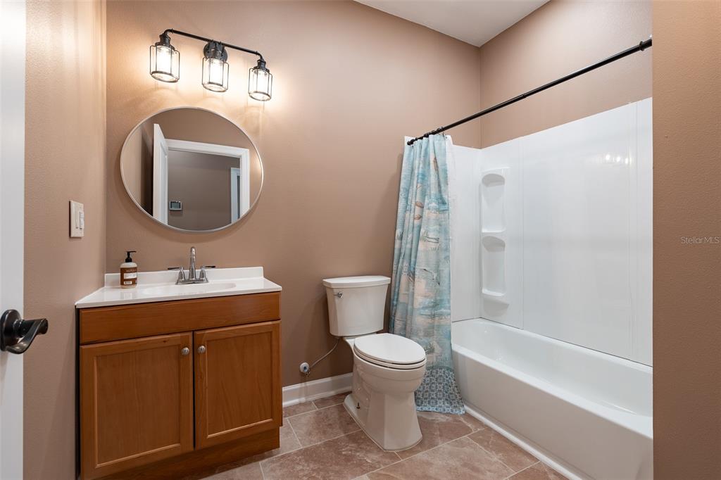6425 Cartwrite Road Spring Hill, FL 34609 - Photo 39 of 74 a bathroom with a toilet sink and mirror