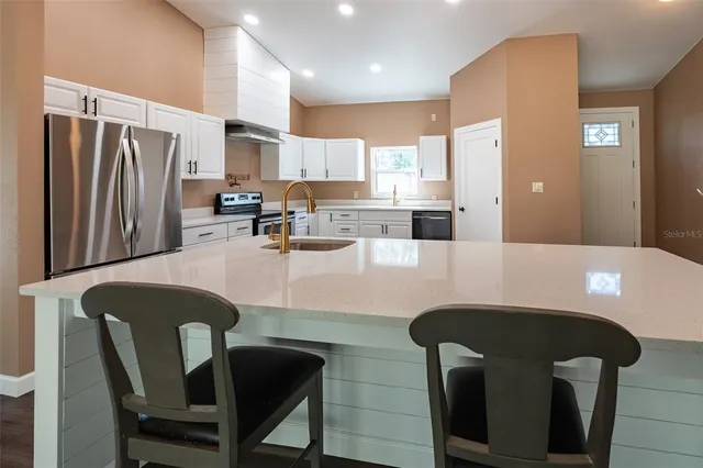 a kitchen with a sink cabinets and a window