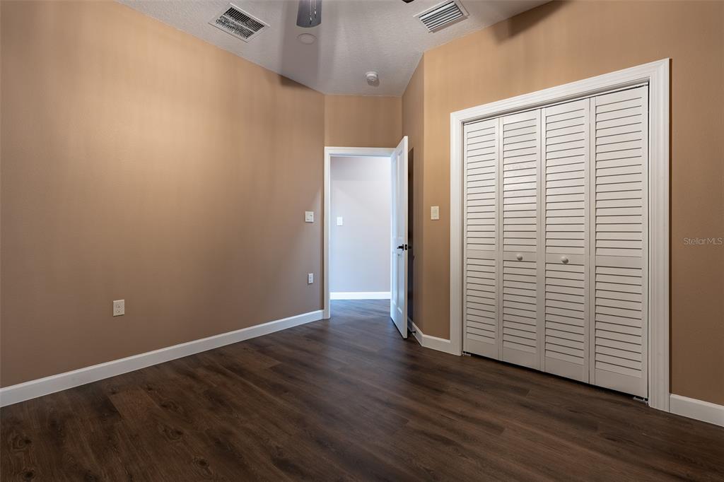 6425 Cartwrite Road Spring Hill, FL 34609 - Photo 42 of 74 an empty room with wooden floor and windows