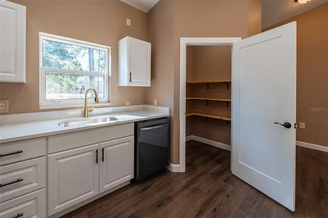 a view of a livingroom with furniture wooden floor and window