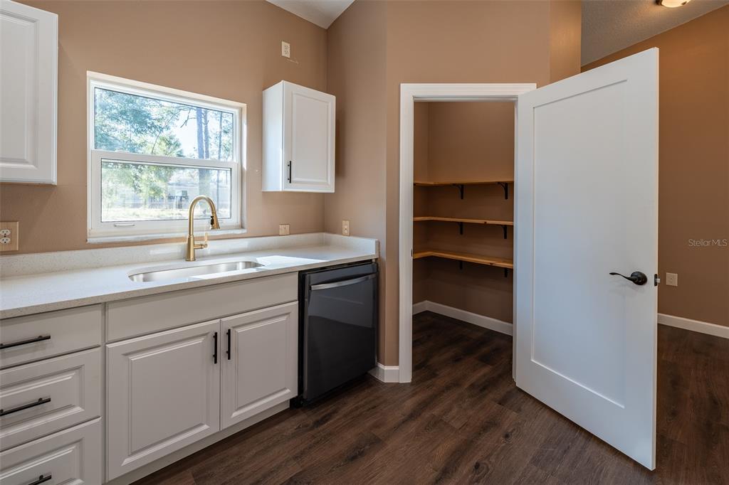 6425 Cartwrite Road Spring Hill, FL 34609 - Photo 5 of 74 a kitchen with a sink cabinets and a window