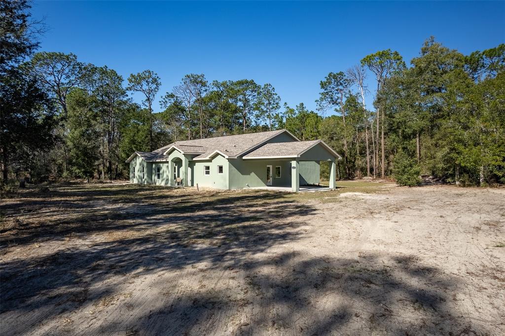 6425 Cartwrite Road Spring Hill, FL 34609 - Photo 59 of 74 a front view of a house with a yard