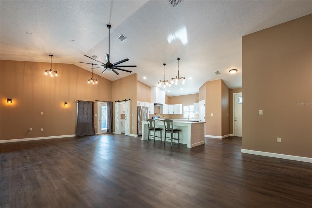 6425 Cartwrite Road Spring Hill, FL 34609 - Photo 10 of 74 an open kitchen with a table and chairs