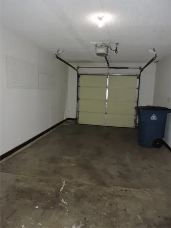 an empty room with a window and a ceiling fan