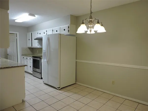 a kitchen with stainless steel appliances a refrigerator and a stove top oven