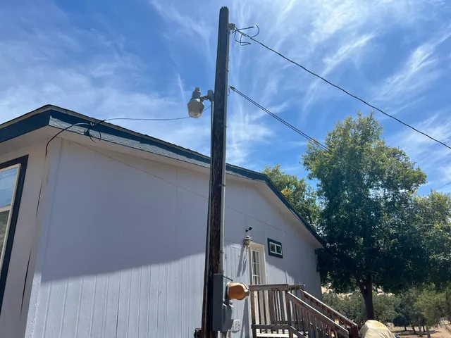 a view of a room that has a large window and furniture
