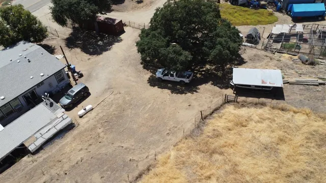 an aerial view of a house with a yard covered in snow