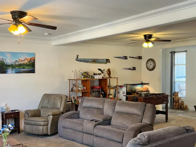 a living room with furniture and a lamp