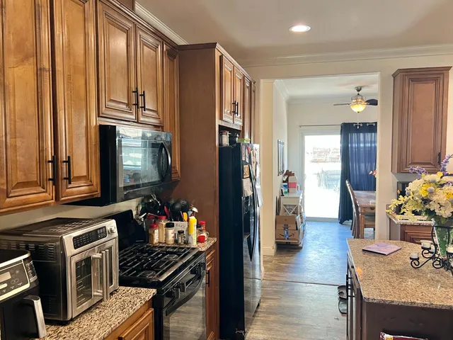 a kitchen with stainless steel appliances a stove refrigerator and a sink