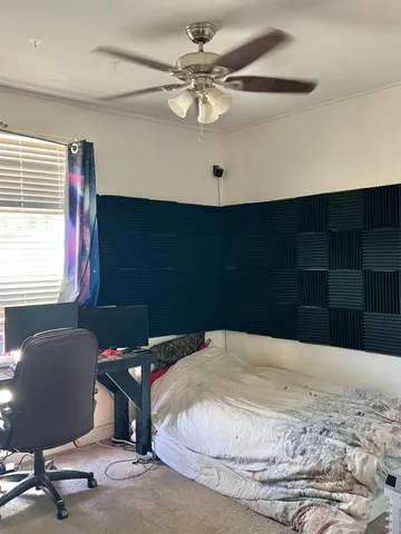 a bedroom with a bed and a chandelier