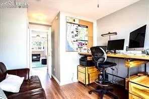 a view of a workspace with furniture and a window
