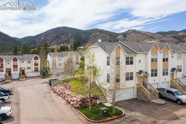 an aerial view of residential houses with outdoor space and parking