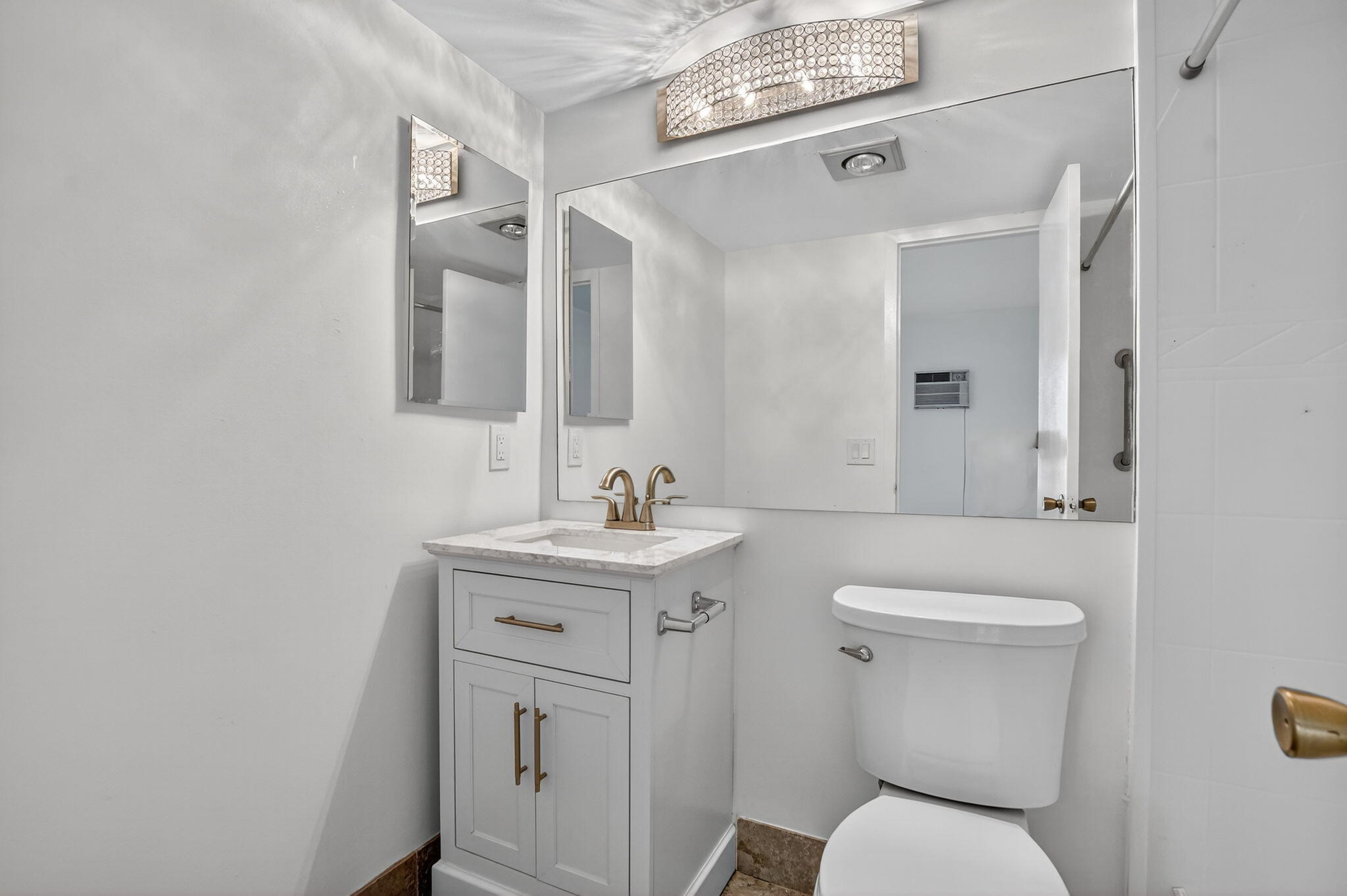 177 Fanshaw East, Unit 177 Boca Raton, FL 33434 - Photo 17 of 70 a bathroom with a toilet a sink and mirror