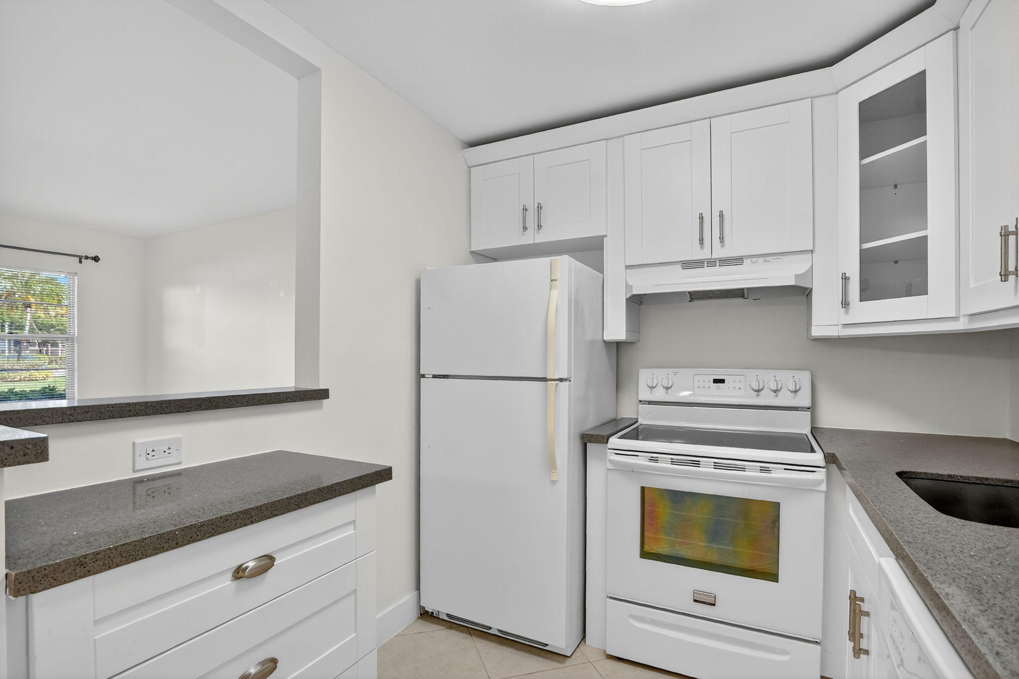 177 Fanshaw East, Unit 177 Boca Raton, FL 33434 - Photo 9 of 70 a kitchen with stainless steel appliances granite countertop a refrigerator sink and stove